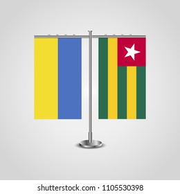 Table stand with flags of Ukraine and Togo.Two flag. Flag pole. Symbolizing the cooperation between the two countries. Table flags