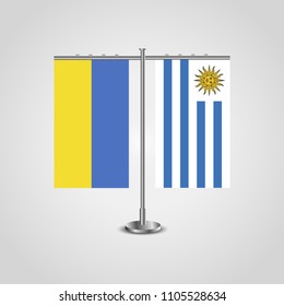 Table stand with flags of Ukraine and Uruguay.Two flag. Flag pole. Symbolizing the cooperation between the two countries. Table flags