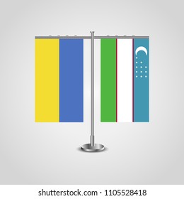Table stand with flags of Ukraine and Uzbekistan.Two flag. Flag pole. Symbolizing the cooperation between the two countries. Table flags