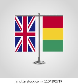 Table stand with flags of United Kingdom and Guinea.Two flag. Flag pole. Symbolizing the cooperation between the two countries. Table flags