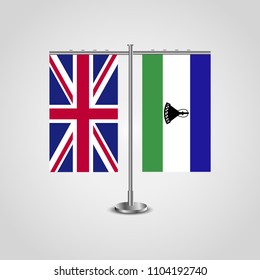 Table stand with flags of United Kingdom and Lesotho.Two flag. Flag pole. Symbolizing the cooperation between the two countries. Table flags