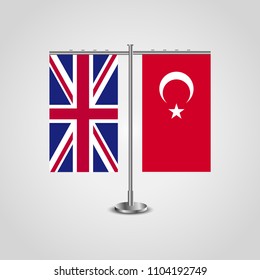 Table stand with flags of United Kingdom and Turkey.Two flag. Flag pole. Symbolizing the cooperation between the two countries. Table flags
