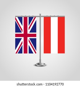 Table stand with flags of United Kingdom and Austria.Two flag. Flag pole. Symbolizing the cooperation between the two countries. Table flags