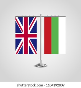 Table stand with flags of United Kingdom and Bulgaria.Two flag. Flag pole. Symbolizing the cooperation between the two countries. Table flags