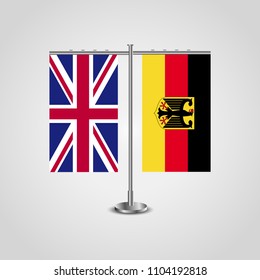Table stand with flags of United Kingdom and Germany.Two flag. Flag pole. Symbolizing the cooperation between the two countries. Table flags