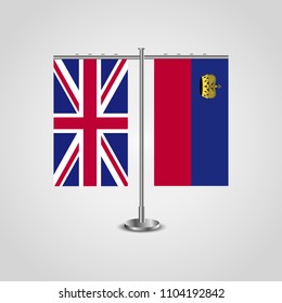 Table stand with flags of United Kingdom and Liechtenstein.Two flag. Flag pole. Symbolizing the cooperation between the two countries. Table flags