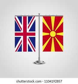 Table stand with flags of United Kingdom and Macedonia.Two flag. Flag pole. Symbolizing the cooperation between the two countries. Table flags