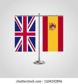 Table stand with flags of United Kingdom and Spain.Two flag. Flag pole. Symbolizing the cooperation between the two countries. Table flags