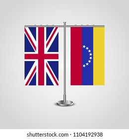 Table stand with flags of United Kingdom and Venezuela.Two flag. Flag pole. Symbolizing the cooperation between the two countries. Table flags