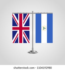 Table stand with flags of United Kingdom and Nicaragua.Two flag. Flag pole. Symbolizing the cooperation between the two countries. Table flags