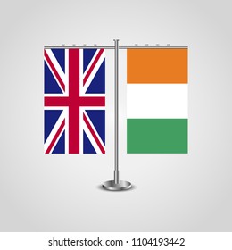 Table stand with flags of United Kingdom and Côte d'Ivoire.Two flag. Flag pole. Symbolizing the cooperation between the two countries. Table flags