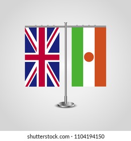 Table stand with flags of United Kingdom and Niger.Two flag. Flag pole. Symbolizing the cooperation between the two countries. Table flags