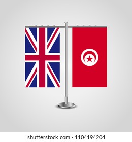 Table stand with flags of United Kingdom and Tunisia.Two flag. Flag pole. Symbolizing the cooperation between the two countries. Table flags