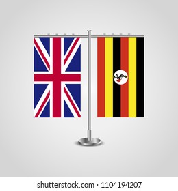 Table stand with flags of United Kingdom and Uganda.Two flag. Flag pole. Symbolizing the cooperation between the two countries. Table flags