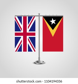 Table stand with flags of United Kingdom and East Timor.Two flag. Flag pole. Symbolizing the cooperation between the two countries. Table flags