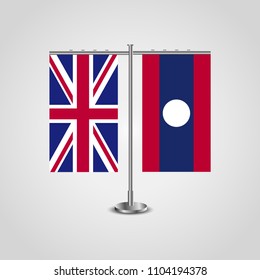 Table stand with flags of United Kingdom and Laos.Two flag. Flag pole. Symbolizing the cooperation between the two countries. Table flags