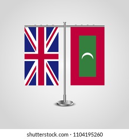 Table stand with flags of United Kingdom and Maldives.Two flag. Flag pole. Symbolizing the cooperation between the two countries. Table flags