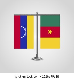 Table stand with flags of Venezuela and Cameroon. Two flag. Flag pole. Symbolizing the cooperation between the two countries. Table flags