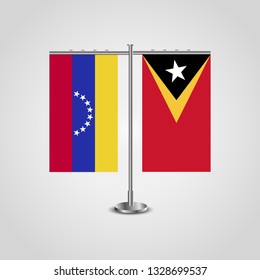 Table stand with flags of Venezuela and East Timor. Two flag. Flag pole. Symbolizing the cooperation between the two countries. Table flags