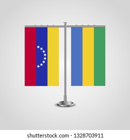 Table stand with flags of Venezuela and Gabon. Two flag. Flag pole. Symbolizing the cooperation between the two countries. Table flags

