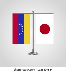Table stand with flags of Venezuela and Japan. Two flag. Flag pole. Symbolizing the cooperation between the two countries. Table flags

