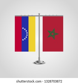 Table stand with flags of Venezuela and Morocco. Two flag. Flag pole. Symbolizing the cooperation between the two countries. Table flags