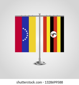 Table stand with flags of Venezuela and Uganda. Two flag. Flag pole. Symbolizing the cooperation between the two countries. Table flags