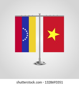 Table stand with flags of Venezuela and Vietnam. Two flag. Flag pole. Symbolizing the cooperation between the two countries. Table flags

