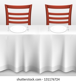 table with a tablecloth and chair