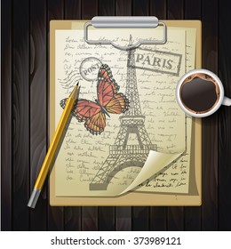 table top with sketching paper and butterfly