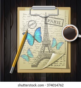 table top with sketching paper and butterfly