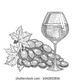 Table white grape wine in a glass and a branch of light grapes