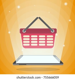 Tablet computer with shopping basket in its light. Concept for new mobile technologies, online shopping, e-commerce
