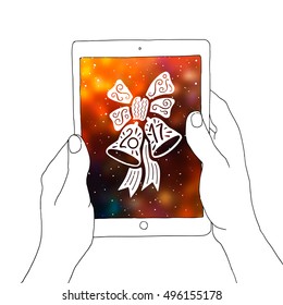 Tablet in his hands with a Christmas picture. Christmas vintage silhouettes bells with greeting lettering and 2017. Bells on a white background.