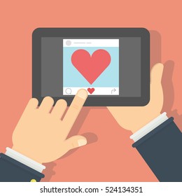 Tablet with like button. Hands holding tablet with heart-shaped like button on the screen. Concept of social networks, sharing.