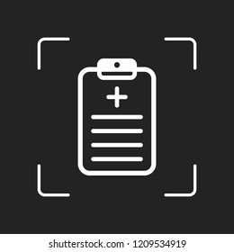 tablet, medical document. White object in camera autofocus on dark background