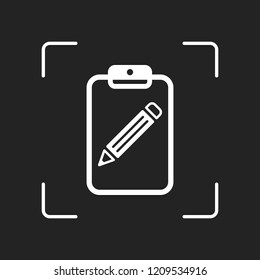 tablet, paper and pencil. White object in camera autofocus on dark background