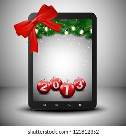 Tablet with pine trees and ornaments in Christmas spirit.