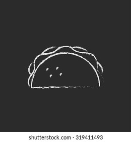 Taco hand drawn in chalk on a blackboard vector white icon isolated on a black background.