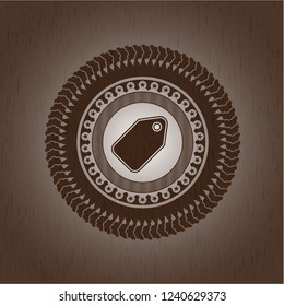 tag icon inside badge with wood background