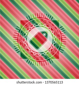 tag icon inside christmas emblem.