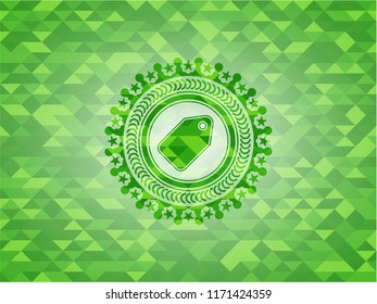 tag icon inside green emblem with triangle mosaic background