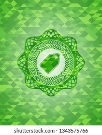 tag icon inside green emblem. Mosaic background