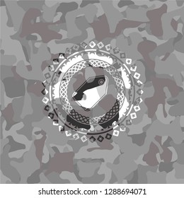 tag icon inside grey camouflaged emblem