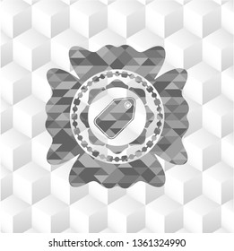 tag icon inside grey emblem with geometric cube white background