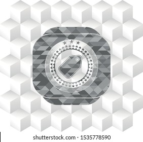 tag icon inside realistic grey emblem with geometric cube white background
