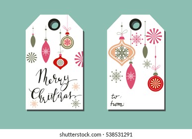 tags with Christmas decorations on light background