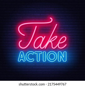 Take Action neon quote on a brick wall.