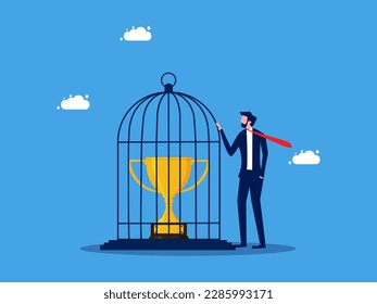 Take control of the victory. Businessman imprisoned the trophy in the birdcage. business concept