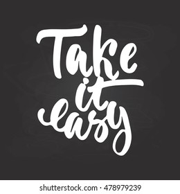 Take it easy - hand drawn lettering phrase isolated on the chalkboard background. Fun brush ink inscription for photo overlays, greeting card or t-shirt print, poster design